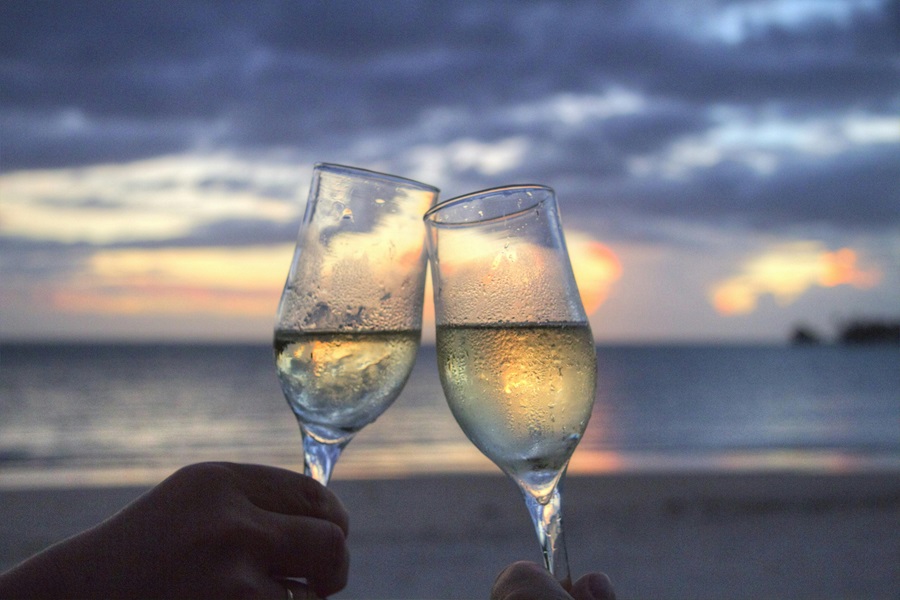 Easy Dinner Recipes For Two Two Wine Glasses Being Clinked Together with an Ocean in the Background