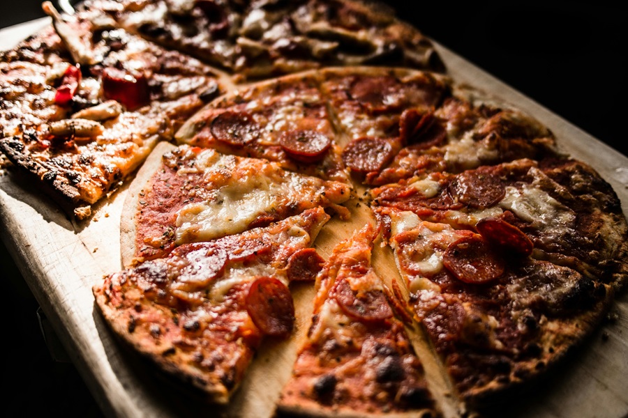 Best Pizza Recipes Close Up of Two Pepperoni Pizzas on a Wooden Surface