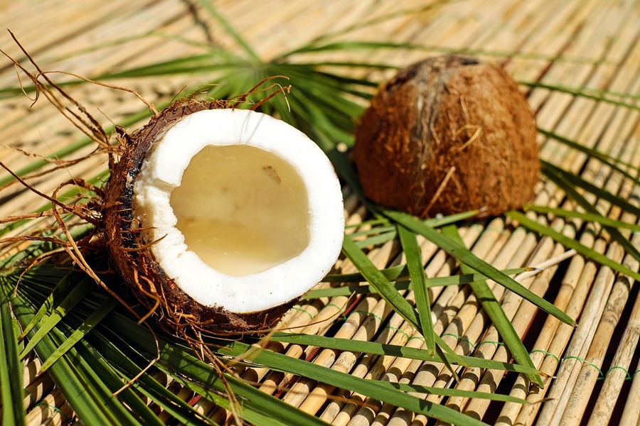 Grab and Go Quick Snacks a Coconut Cut in Half on a Bamboo Bed