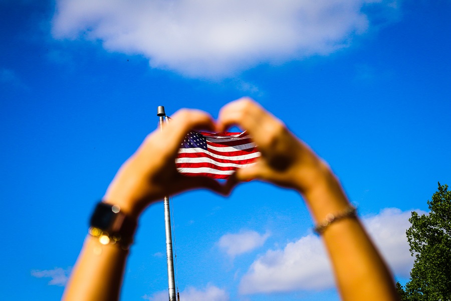 Red White and Blue Nails  a Woman's Hands in the Shape of a Heart with an American Flag in the Background