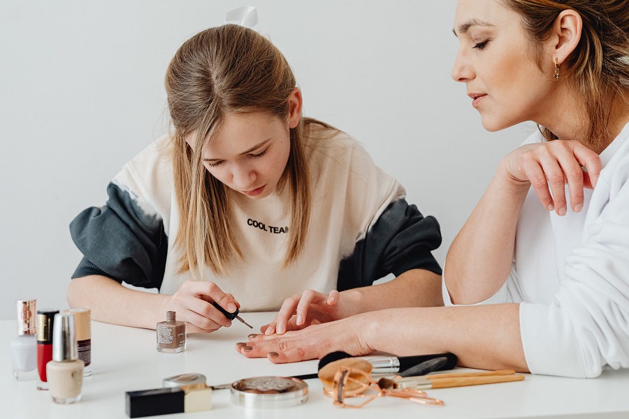 Red White and Blue Nails  a Woman Painting Another Woman's Nails