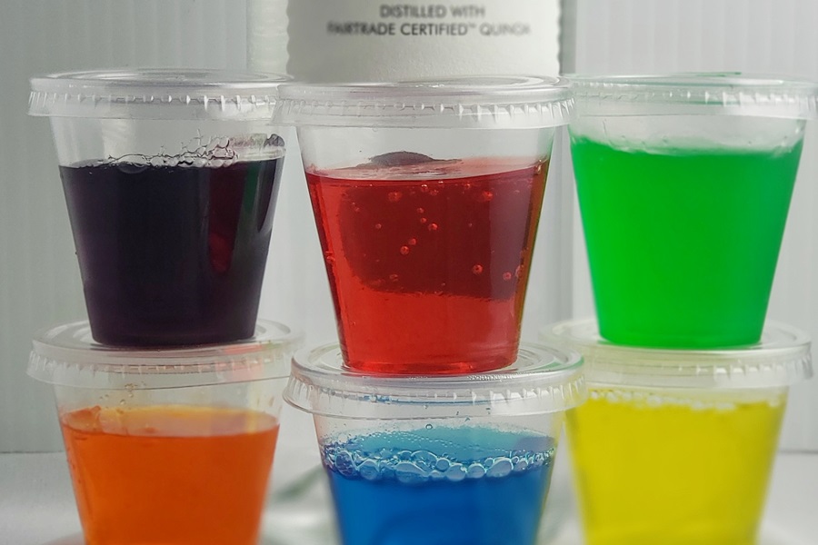 How to Make Jello Shots with Vodka Stacked on Top of Each Other in Front of a Bottle of Vodka