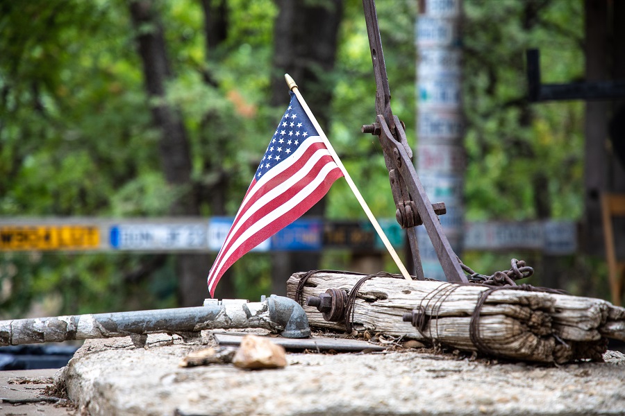 Fourth of July Facts to Know a Small American Flag Sticking Out of a Wooden Raft