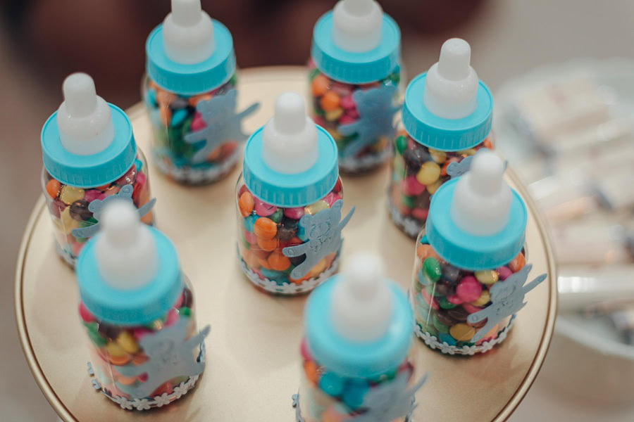 Baby Shower Ideas for Boys Blue and Clear Baby Bottles Filled with Candy on a Table