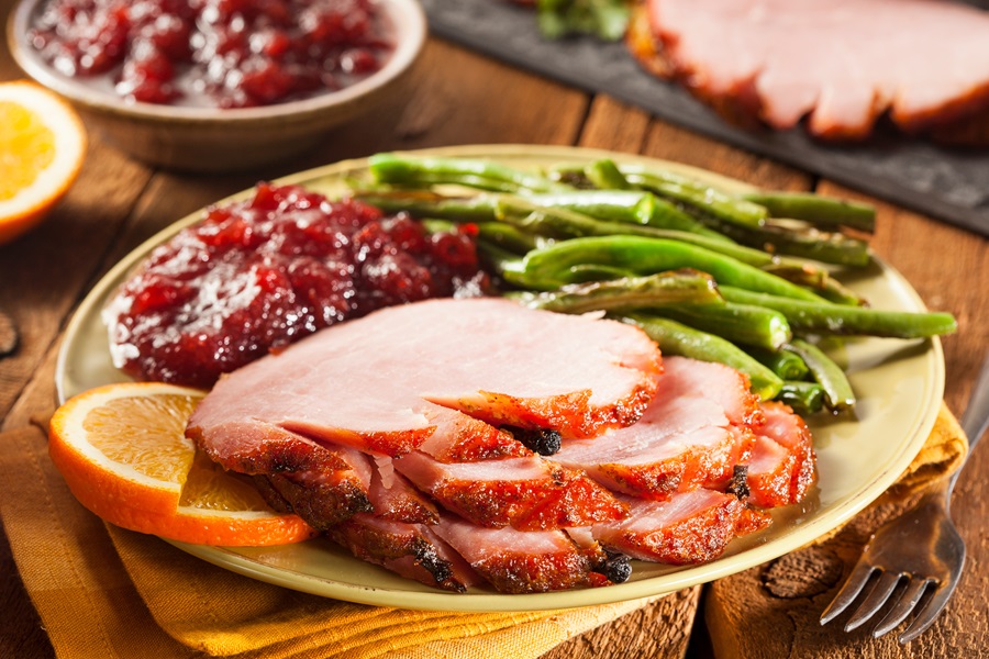 How to Cook A Ham Like A Pro a Plate with Ham Slices, Asparagus, and Cranberry Sauce 