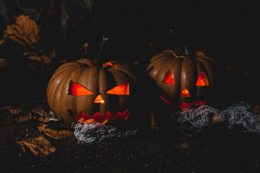 Halloween Cocktails with Whiskey Close Up of Two Lit Jack O Lanterns