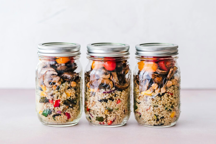 Quinoa Breakfast Recipes a Line of Three Mason Jars Each Filled with Quinoa and Fruit