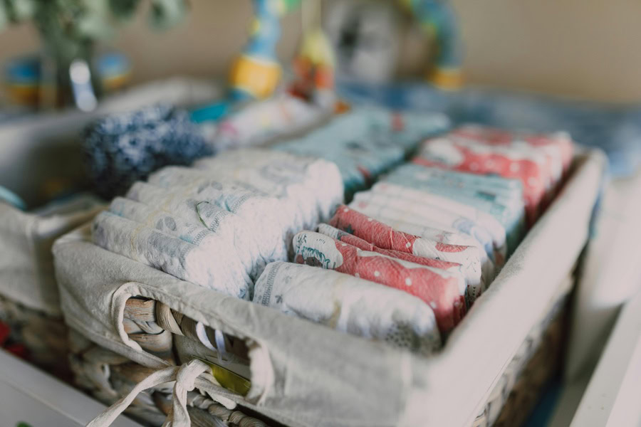 Baby Shower Ideas for Girls Close Up of a Box Filled with Diapers in a Row