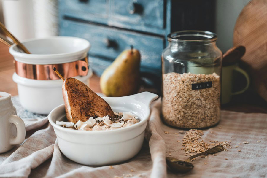 Best Overnight Oats in a Jar Recipes a Small Bowl of Oats with a Roasted Pear Next to a Small Jar of Dry Rolled Oats