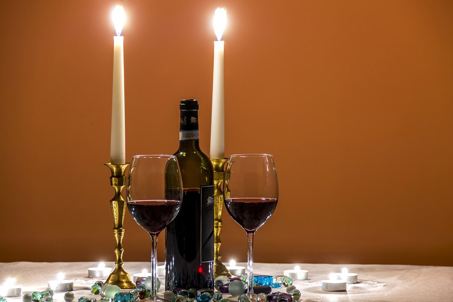 Easy Date Night Recipes Close Up of Two Candles, Wine Glasses, and Plates on a Table