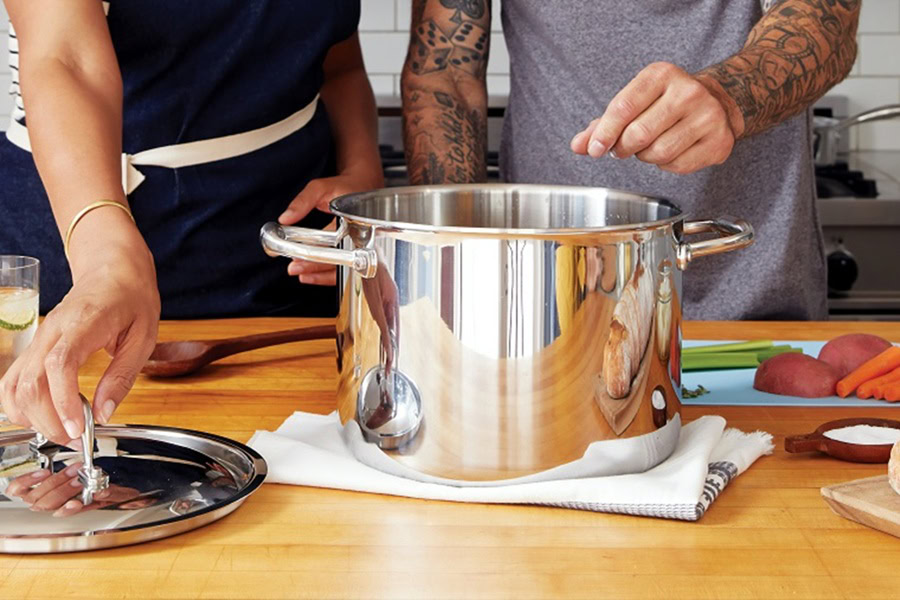 Easy Date Night Recipes Close Up of a Couple Adding Ingredients to a Stew Pot