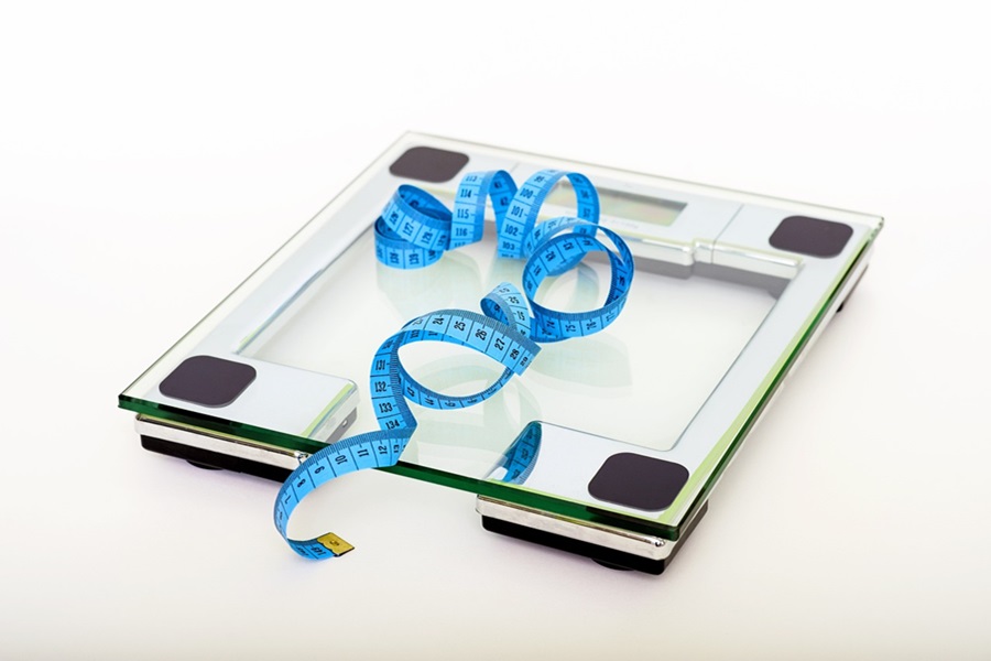 Whole30 Diet Rules a Scale with a Blue Measuring Tape