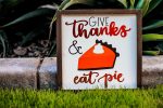 Easy Printable Thanksgiving Games Close Up of a Yard Sign That Says Give Thanks & Pie with a Picture of a Pumpkin Pie Slice Topped with a Dollop of Whipped Cream