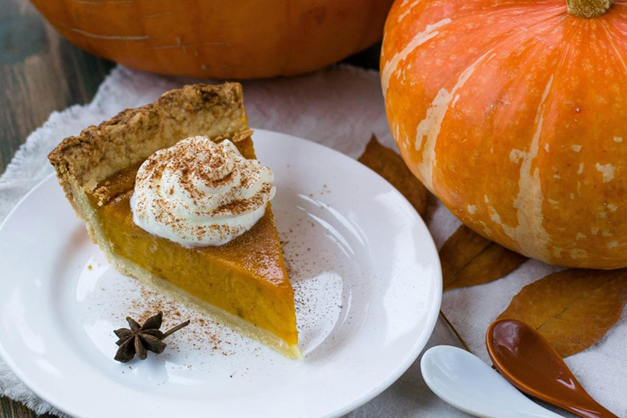 Printable Thanksgiving Games Close Up of a Slice of Pie Topped with a Dollop of Whipped Cream and Cinnamon Sprinkled On Top
