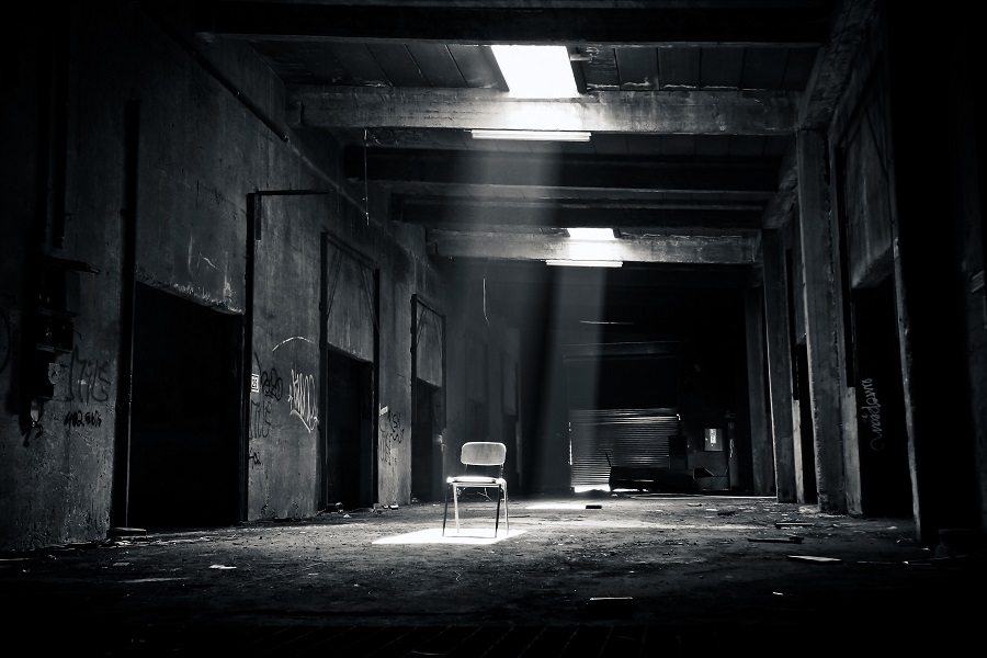 Scary Netflix Movies View of a Hallway in an Abandoned Building with a Single Chair in the Middle