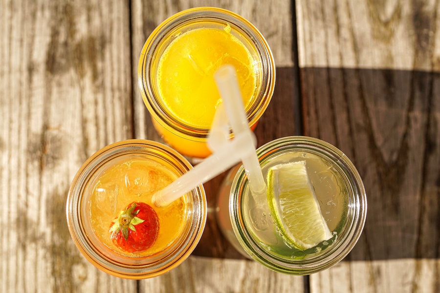 Best Juices for Quick Weight Loss Overhead of Three Glasses of Juice Each with a Straw