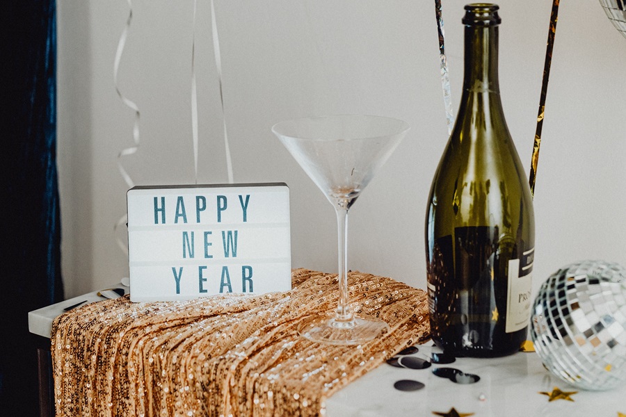 New Year's Eve Quotes a Letterboard That Says 'Happy New year' Next to a Martini Glass and a Bottle of Champagne