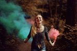Quotes About Change in Life Woman Walking Through a Forest Holding Two Smoke Canons One with Blue Smoke and the Other with Red Smoke