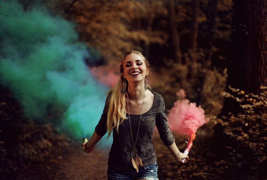 Quotes About Change in Life Woman Walking Through a Forest Holding Two Smoke Canons One with Blue Smoke and the Other with Red Smoke