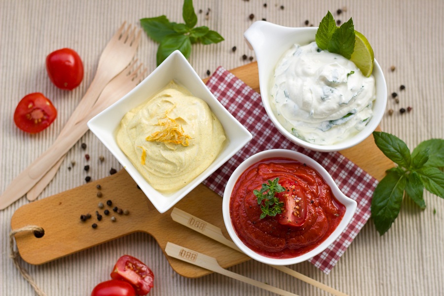 Whole30 Friendly Sauces and Dips Overhead View of Small Dishes Filled with Sauces Surrounded by Different Ingredients