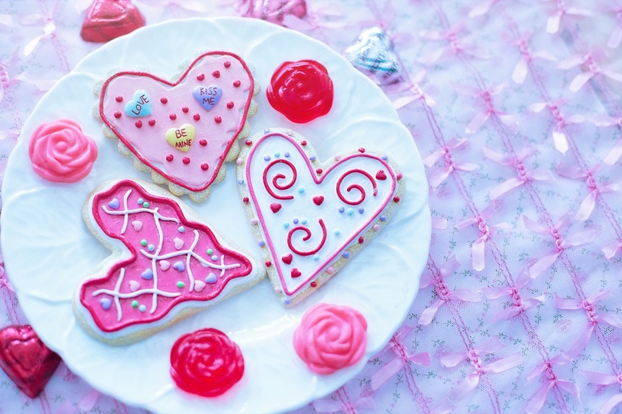 Fun and Free Valentine's Day Printables for Kids a White Plate with Heart-Shaped Cookies in Red, Pink, and White Icing