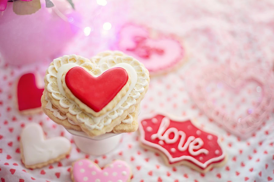 Fun and Free Valentine's Day Printables for Kids a Stack of heart-Shaped Cookies with Red Icing, One With Love Written On It