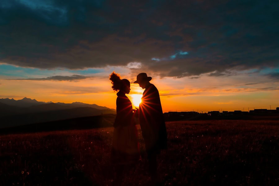 Romantic Valentine's Day Quotes for Him a Silhouette of a Couple Standing Together in Front of a Sunset