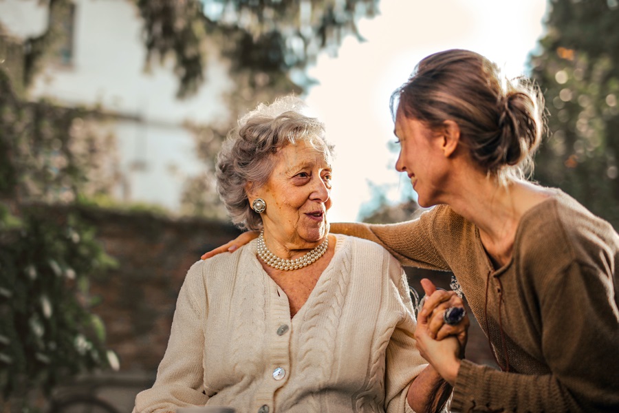 Best Quotes About Getting Older An Elderly Woman Sitting on a Bench with Her Adult Daughter