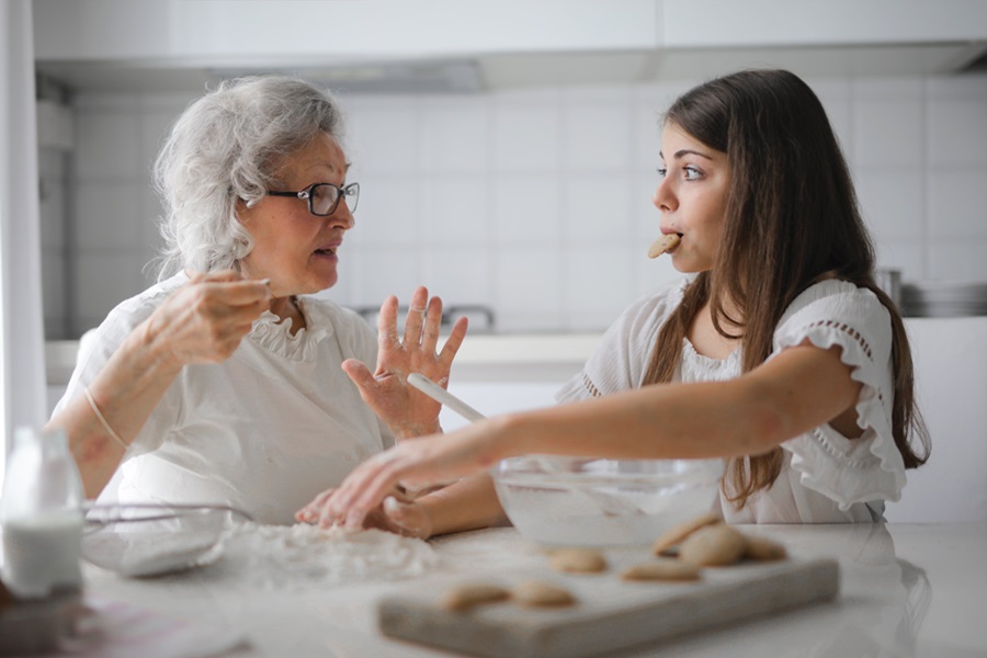 Best Quotes About Getting Older An Elderly Woman Baking with Her Grand Daughter in a Kitchen