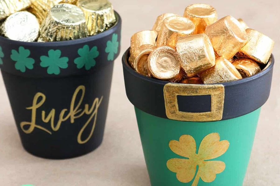 Creative St Patricks Day Decorations on a Budget Close Up of Two Painted Clay Pots One Filled with Rolo Candies and The Other Filled with Reese's Candies
