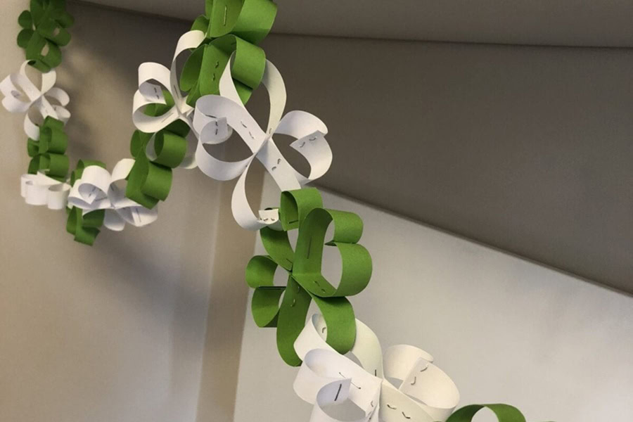 Creative St Patricks Day Decorations on a Budget a Paper Shamrock Garland Hanging From a Wall