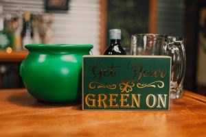 Creative St Patricks Day Decorations on a Budget Close Up of a Green Pot of Gold Next to a Small Sign That Says Get Your Green On