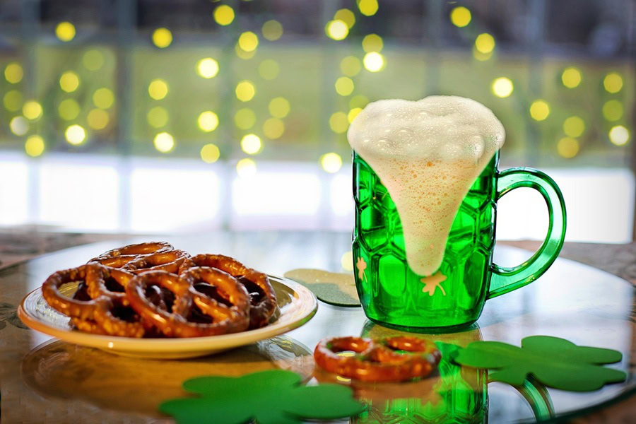 Green Cocktails for St. Patrick's Day a Green Mug of Beer Next to a Small Plate of Pretzels 