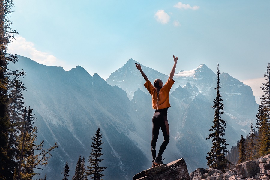 Quotes About New Beginnings After Divorce Woman Standing on a Rock with Mountains in Front of Her and Her Arms in the Air