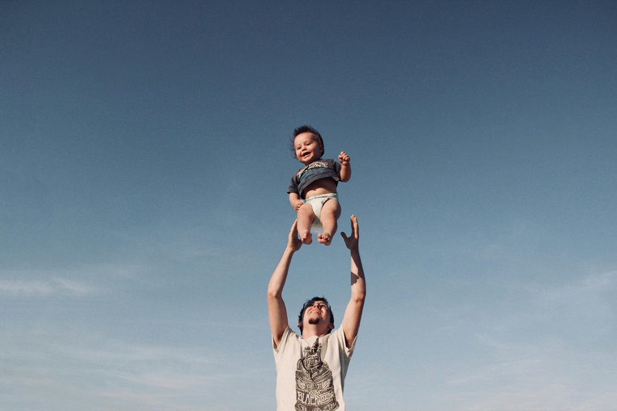Inspirational Quotes for Parents to Be a Father Throwing His Child in the Air