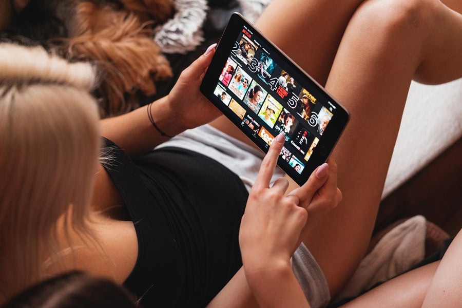 Netflix Shows Best Shows to Watch for All Ages a Woman Watching Netflix on a Tablet