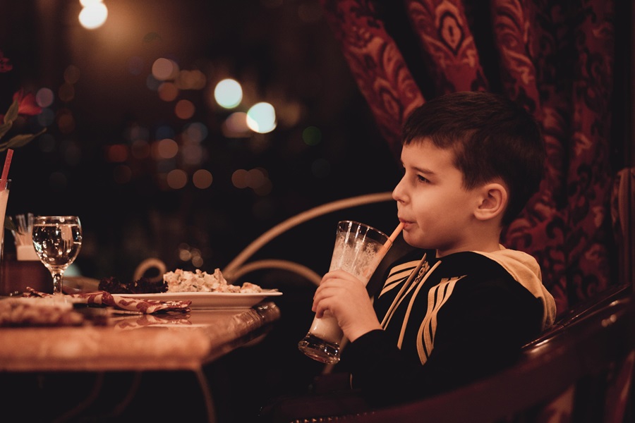5 Best Restaurants in San Diego to Go to with Kids a Young Boy Sitting at a Restaurant Sipping a Drink