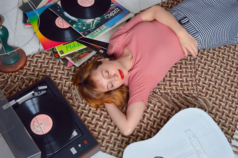 Best Tourist Things to Do in LA A Woman Lying Down Listening to a Record Playing Next to Her