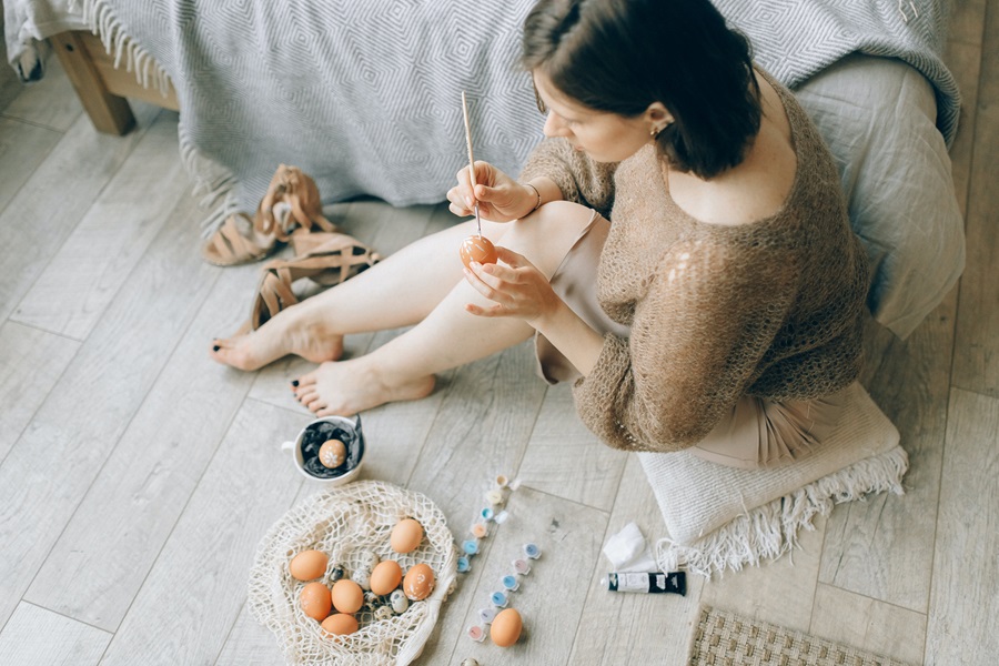 Easter Basket Ideas for Adults a Woman Sitting on the Floor Painting Eggs Next to Her Bed