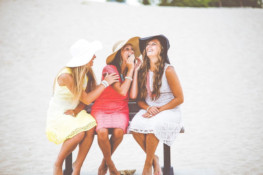 Hilarious Smartass Quotes Three Women on a Beach Wearing Sun Dresses and Floppy Hats Laughing