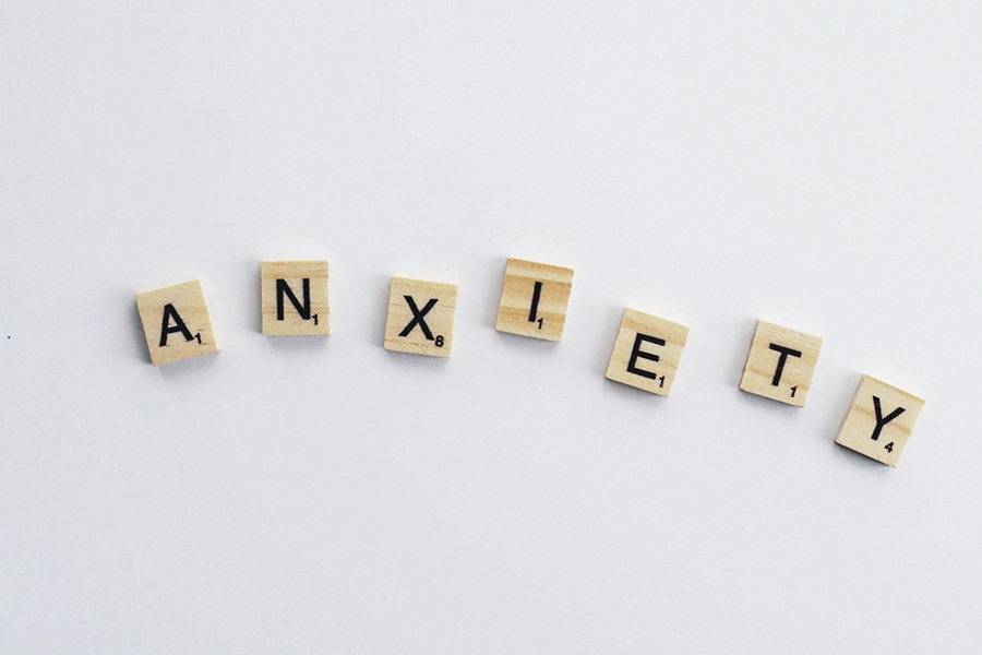 Best Motivational Quotes for People Who Struggle with Anxiety Letter Tiles on a White Surface Spelling Out Anxiety