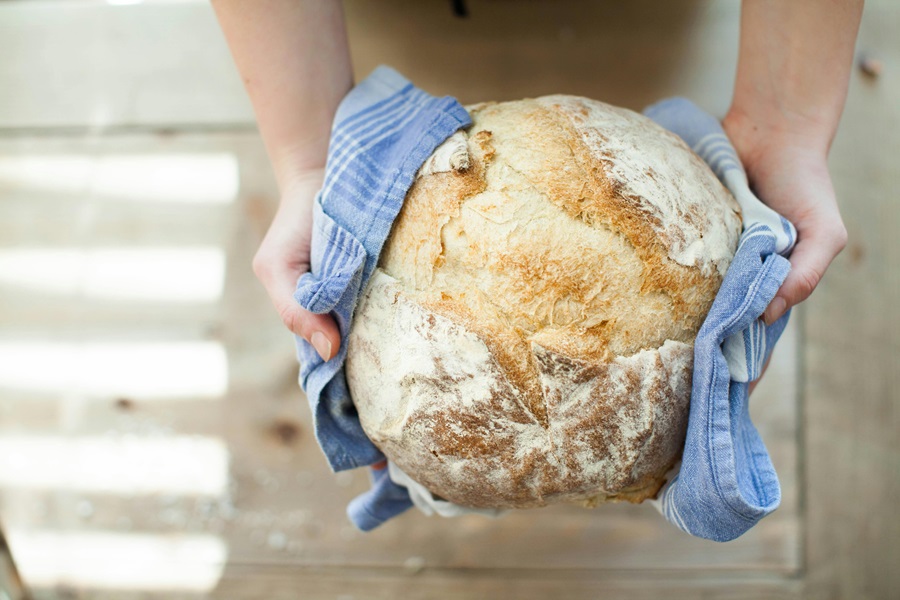 Gluten Free Beer Bread Recipes Close Up of a Person Holding a Freshly Baked Loaf of Bread Being Held by a Person