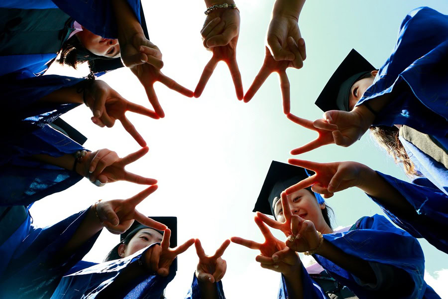 High School Graduation Party Foods a Group of Teens Wearing Grad Robes and Caps Standing in a Circle Holding Up Peace Signs in a Circle