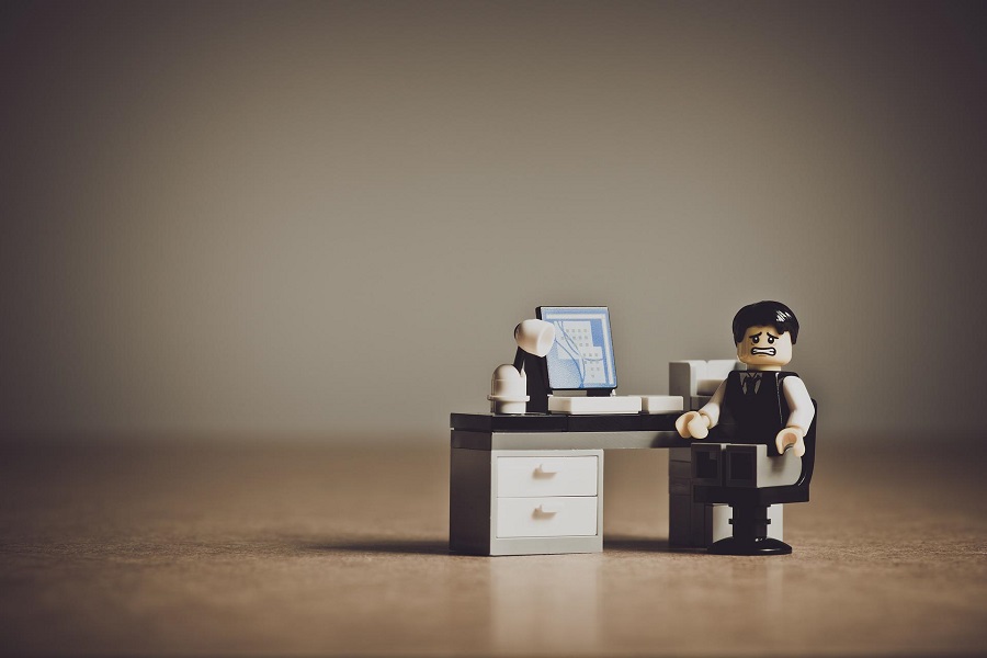 Funny Smartass Quotes About Work Lego Figure of a Man in a Suit Sitting at a Desk