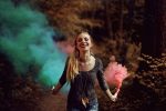 Short Inspirational Quotes Woman Walking Through the Woods Holding Smoke Bombs Letting Off Smoke Behind Her Blue Smoke in one Hand and Pink Smoke in the Other