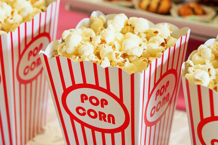 Free Things to do in Denver for Kids Close Up of Popcorn Buckets with Red and White Stripes Filled with Popcorn