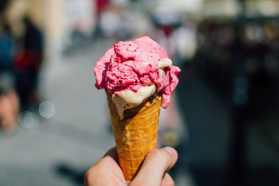 7 Things to do in Delray Beach During the Day or Night Close Up of a Person's Hand Holding an Ice Cream Cone with Pink and White Ice Cream