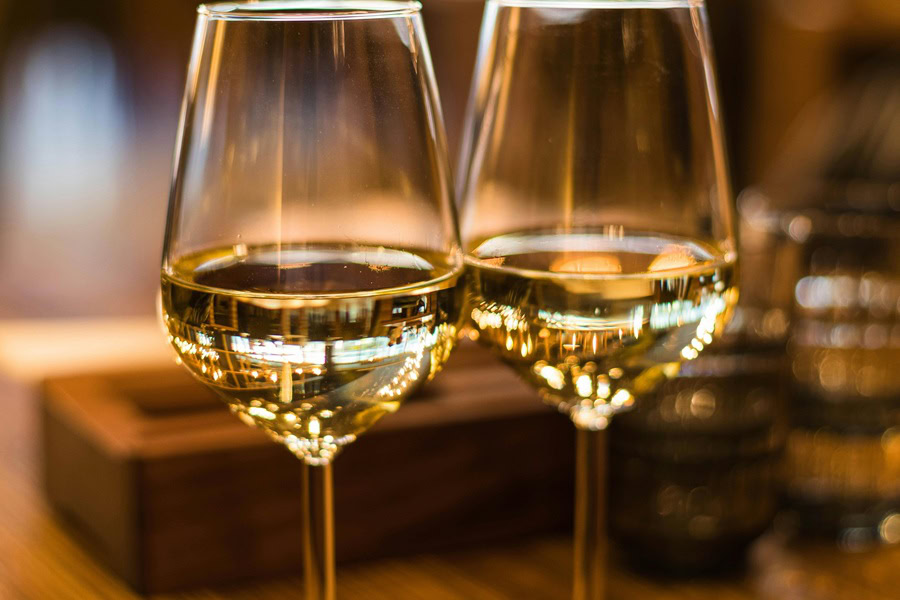 Best White Wines Under 10 Dollars Close Up of Two Wine Glasses Each Half Filled with White Wine