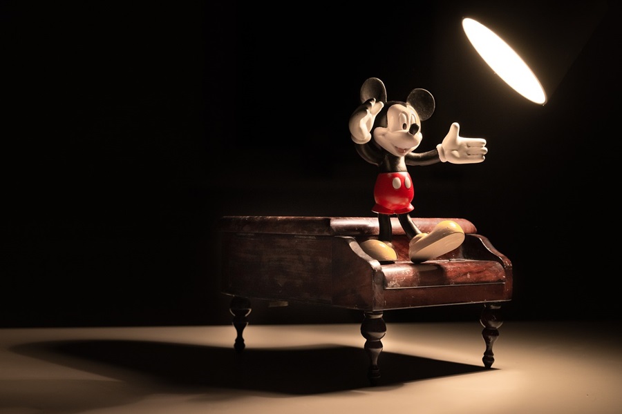 Disney Gifts for All Ages a Mickey Statue on an Artist's Desk with a Single Light Shining on The Desk