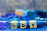 Baby Boy Nursery Ideas Wooden Toy Blocks with Letters Spelling Out Boy in Lower Case Letters on a Blue Blanket